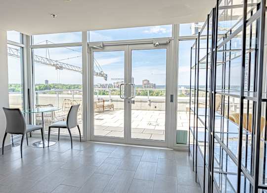 a living room with glass doors and a view of the water