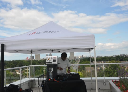 a man standing under a white tent on top of a roof