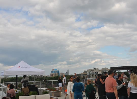 a crowd of people at a party on the roof of a building