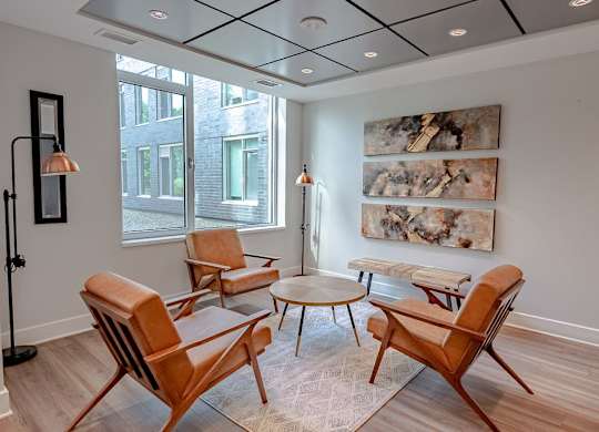 a living room with chairs and a table
