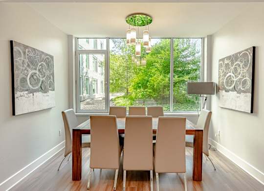 a dining room with a table and chairs and a window