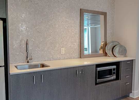 a kitchen with a sink and a mirror