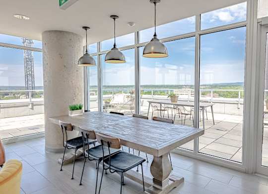 a dining room with large windows and a table with chairs