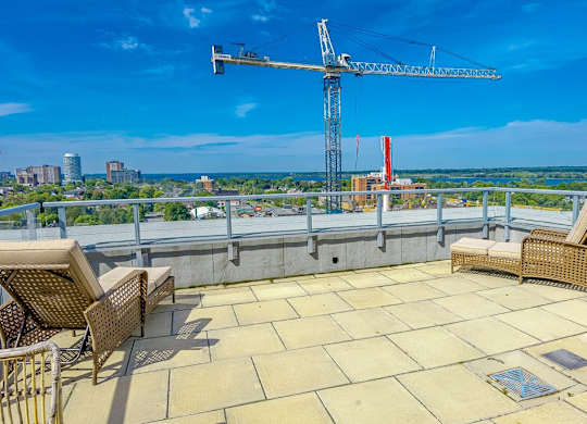 a roof terrace with a view of the city and a crane
