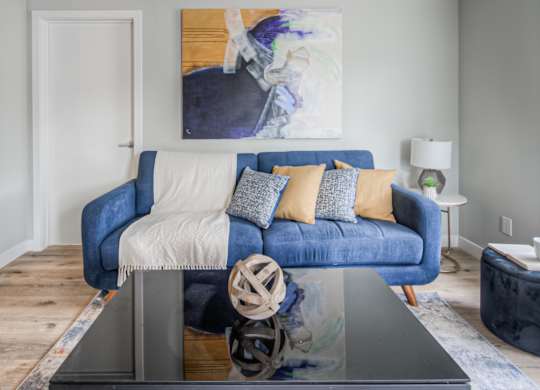a living room with a blue couch and a coffee table