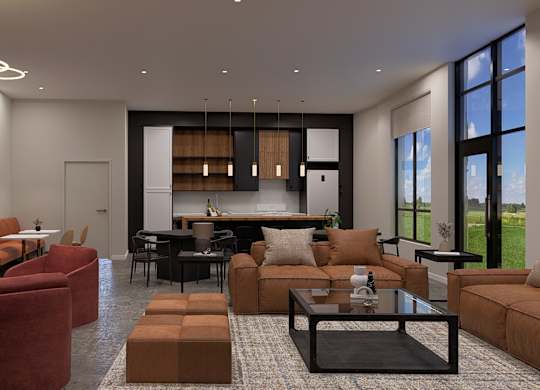 A modern living room with a large window and a kitchen in the background.
