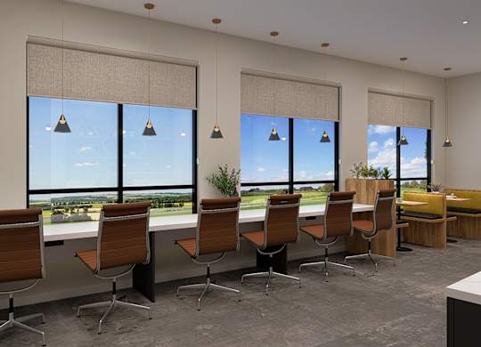 A conference room with a long table and chairs, a whiteboard, and a view of the outdoors through large windows.