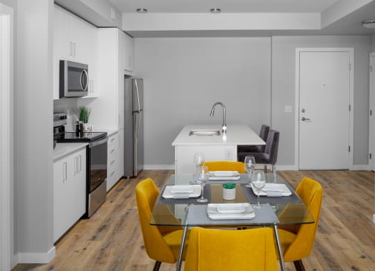 a kitchen and dining area in a 555 waverly unit