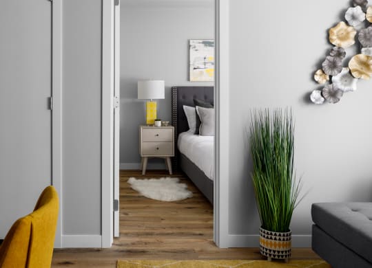 a living room with grey walls and a yellow rug