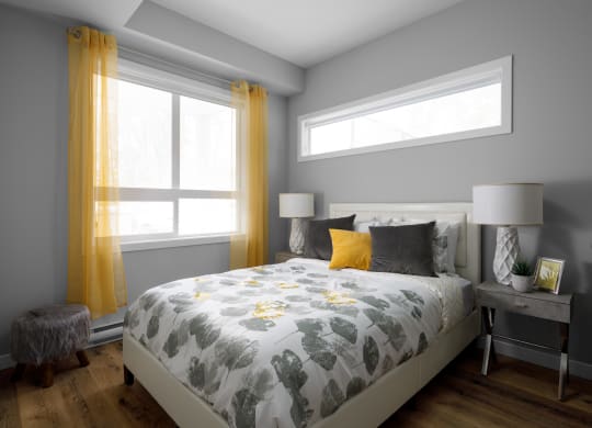 a bedroom with grey walls and yellow curtains