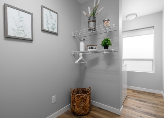 a small bathroom with grey walls and a basket on the floor