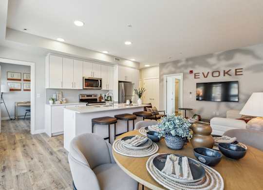 A modern dining room with a wooden table set for a meal.