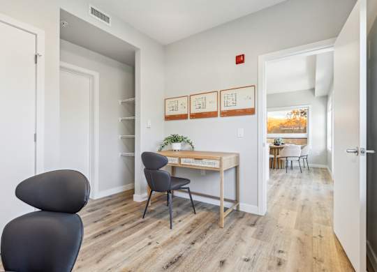 A room with a desk and a chair.