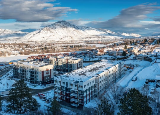 a city covered in snow with a mountain in the background