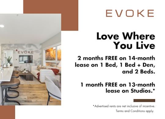 A room with a kitchen and a dining table with chairs and a sign that says EVOKE.