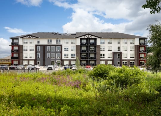 a large apartment building with a parking lot in front of it