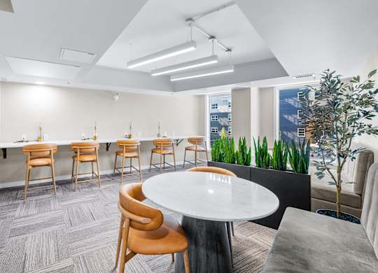 A conference room with a white table and chairs.