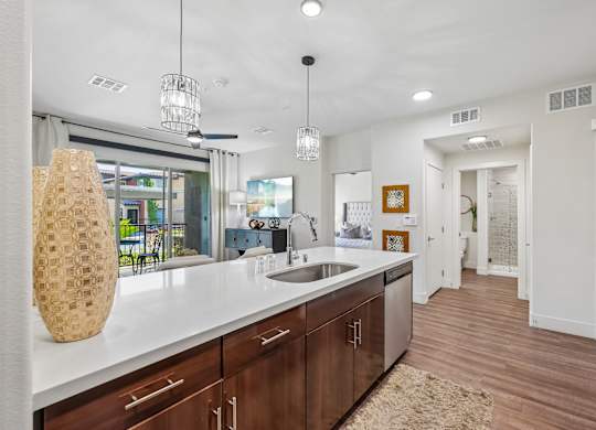 A modern kitchen with wooden cabinets and a white countertop.