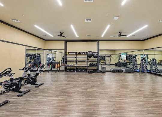 A spacious gym with a variety of exercise equipment.