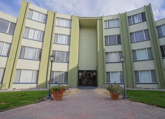 the entrance to an apartment building with a walkway and potted plants at Regency Park, Reno, NV, 89509