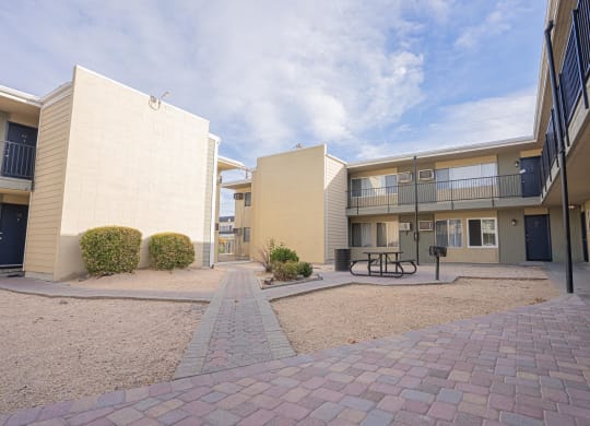 a courtyard between two apartment buildings with a picnic table at Regency Park, Nevada, 89509