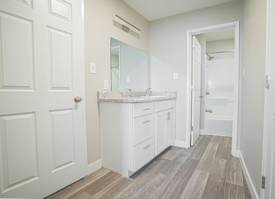 a white bathroom with a sink and a mirror at Regency Park, Nevada