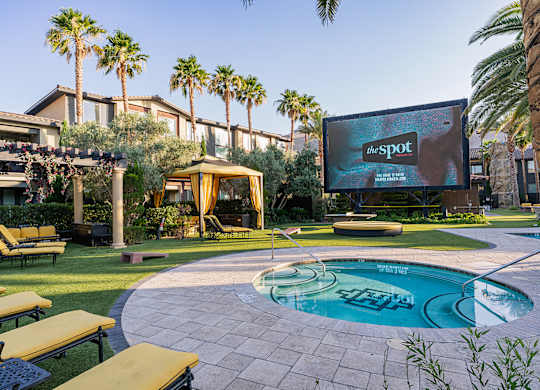 A pool with a hot tub in the middle of it.