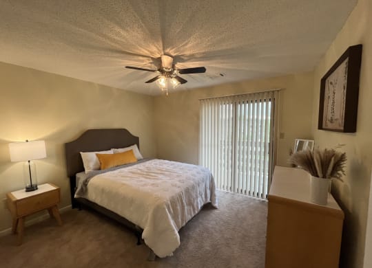 a bedroom with a bed and a ceiling fan at Monroeville Apartments, Monroeville