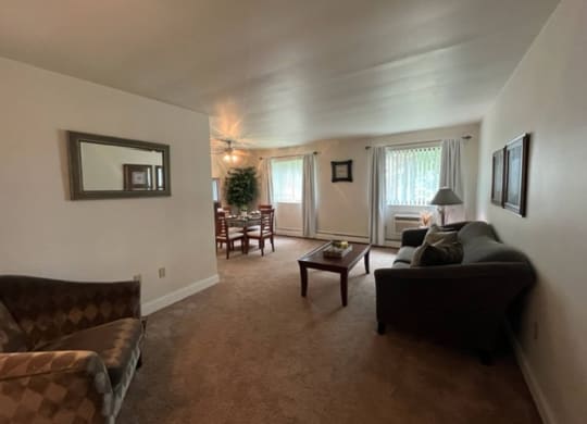 a living room with a couch and a chair at Monroeville Apartments, Monroeville