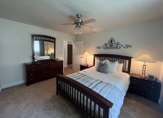 a bedroom with a large bed and a ceiling fan at Monroeville Apartments, Pennslyvania