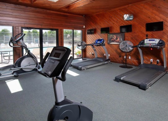 a home gym with a wood paneled walls and ceiling at Monroeville Apartments, Monroeville, PA