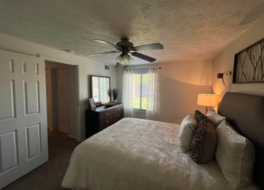 a bedroom with a bed and a ceiling fan at Monroeville Apartments, Monroeville, PA, 15146