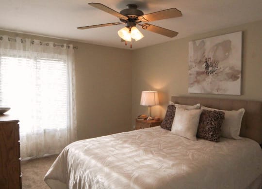 a bedroom with a bed and a ceiling fan at Monroeville Apartments, Pennslyvania, 15146