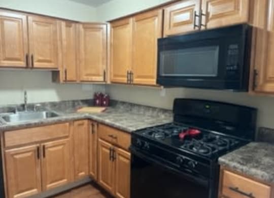 a kitchen with a stove a sink at Monroeville Apartments, Pennslyvania, 15146