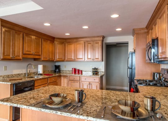 a kitchen with wooden cabinets and granite countertops at Monroeville Apartments, Monroeville, 15146