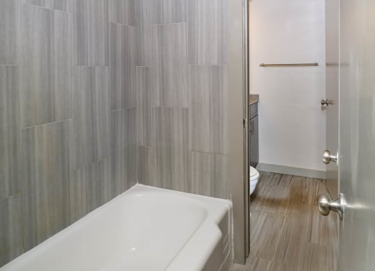 Oval Tub with Subway Tile at Memorial Towers Apartments, The Barvin Group, Houston, TX, 77007