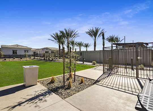 A white container is in the middle of a concrete walkway.