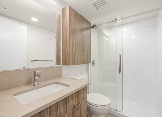 A bathroom with a sink, toilet, and shower.