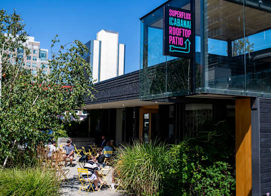 Diners sit on a patio outside a restaurant.