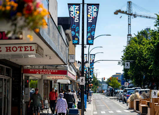 A street scene with a Dutch Bakery and Diner on the left and trees on the right.