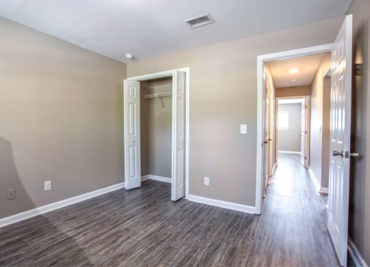 the living room and hallway of a new home with wood flooring