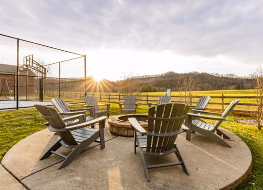 an outdoor patio with chairs and a fire pit