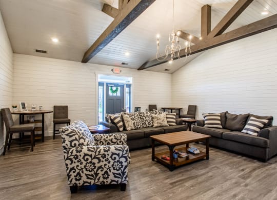 a living room with couches and chairs and a table