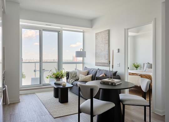 A black and white living room with a view of the city.