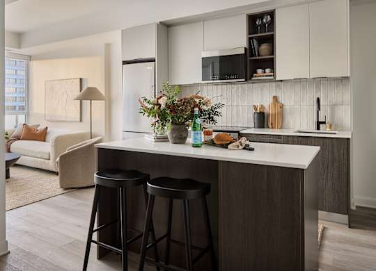 A kitchen with a white counter top and a white fridge.
