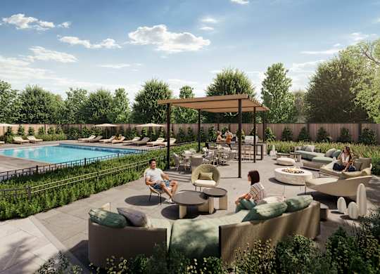 A poolside area with people sitting and enjoying the sun.