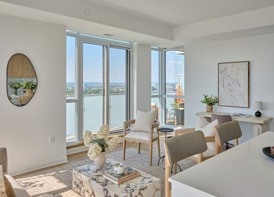 A living room with a view of the city through the windows.