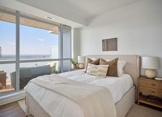 A bedroom with a large bed and a view of the ocean.