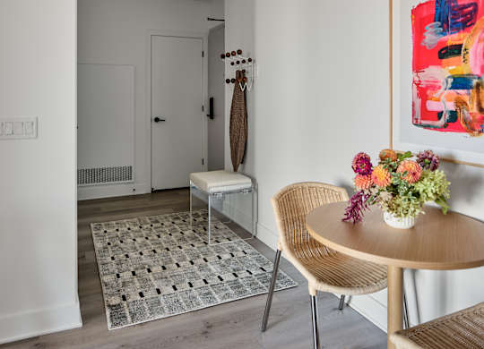 A modern dining room with a round table and chairs.