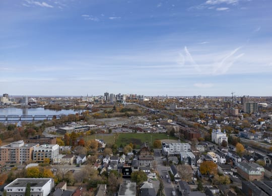 an aerial view of the city with a river and a city skyline